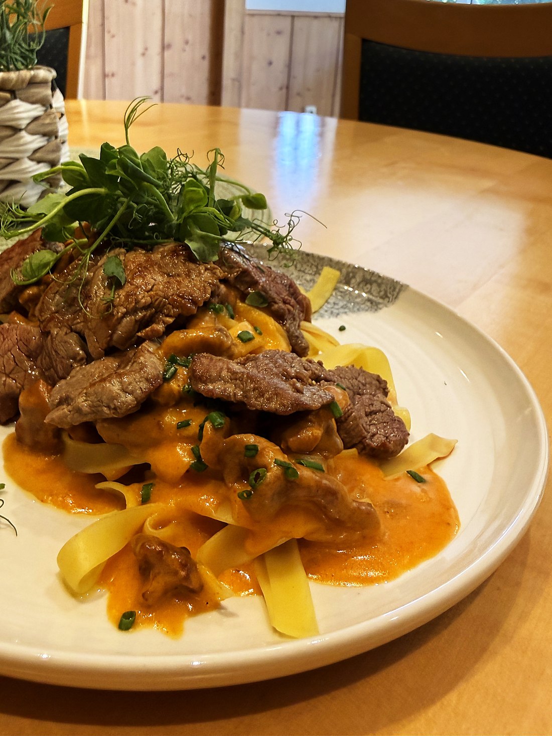Ribbon pasta with strips of beef in paprika cream, plated at the Georgenwirt