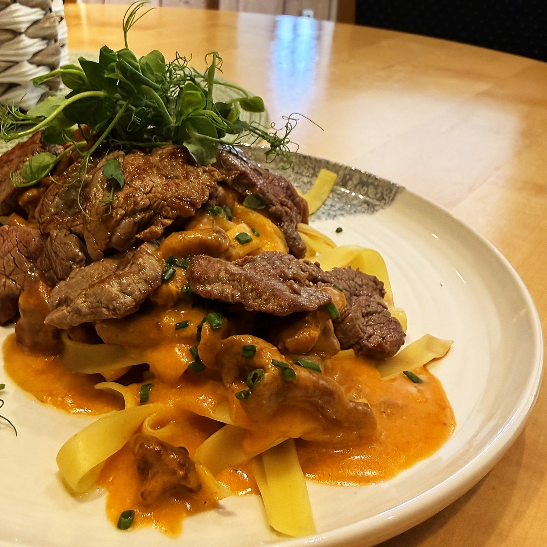 Ribbon pasta with strips of beef in paprika cream, plated at the Georgenwirt